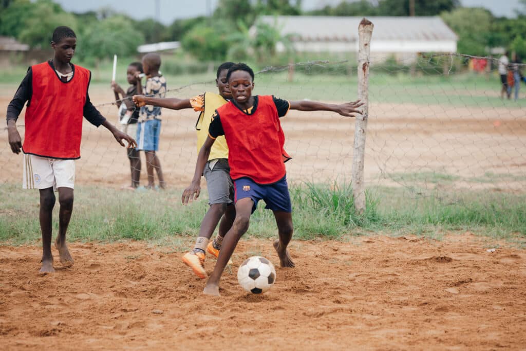 Boys playing football at the pitch.